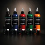 Collection d’encres longue durée pour tatouage temporaire en noir, bleu, rouge, vert et orange, disponibles en flacons de 10 ml et 100 ml.
